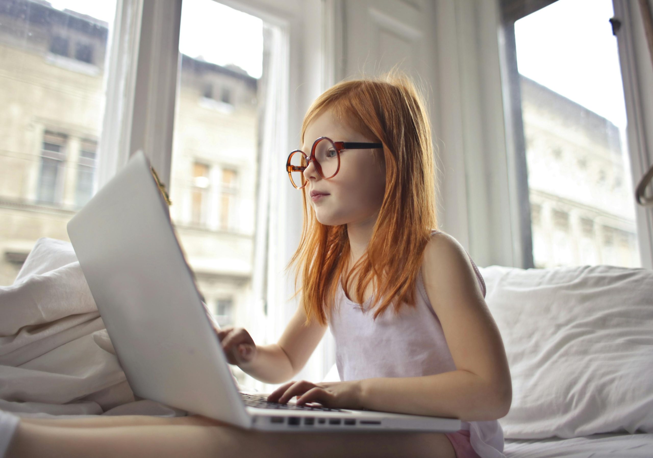 A girl looking at a laptop